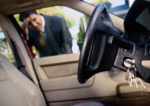 Car keys locked inside vehicle with worried driver outside
